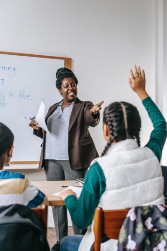 Teacher pointing at student raising hand